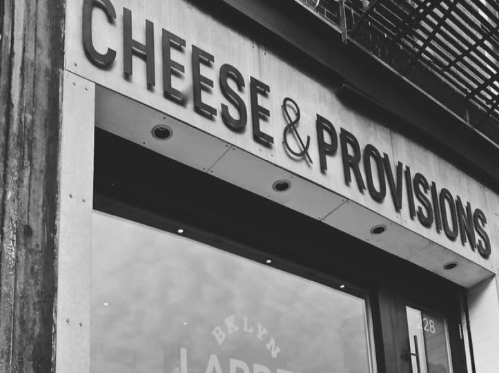 The exterior of the Bklyn Larder store with a sign that says Cheese & Provisions